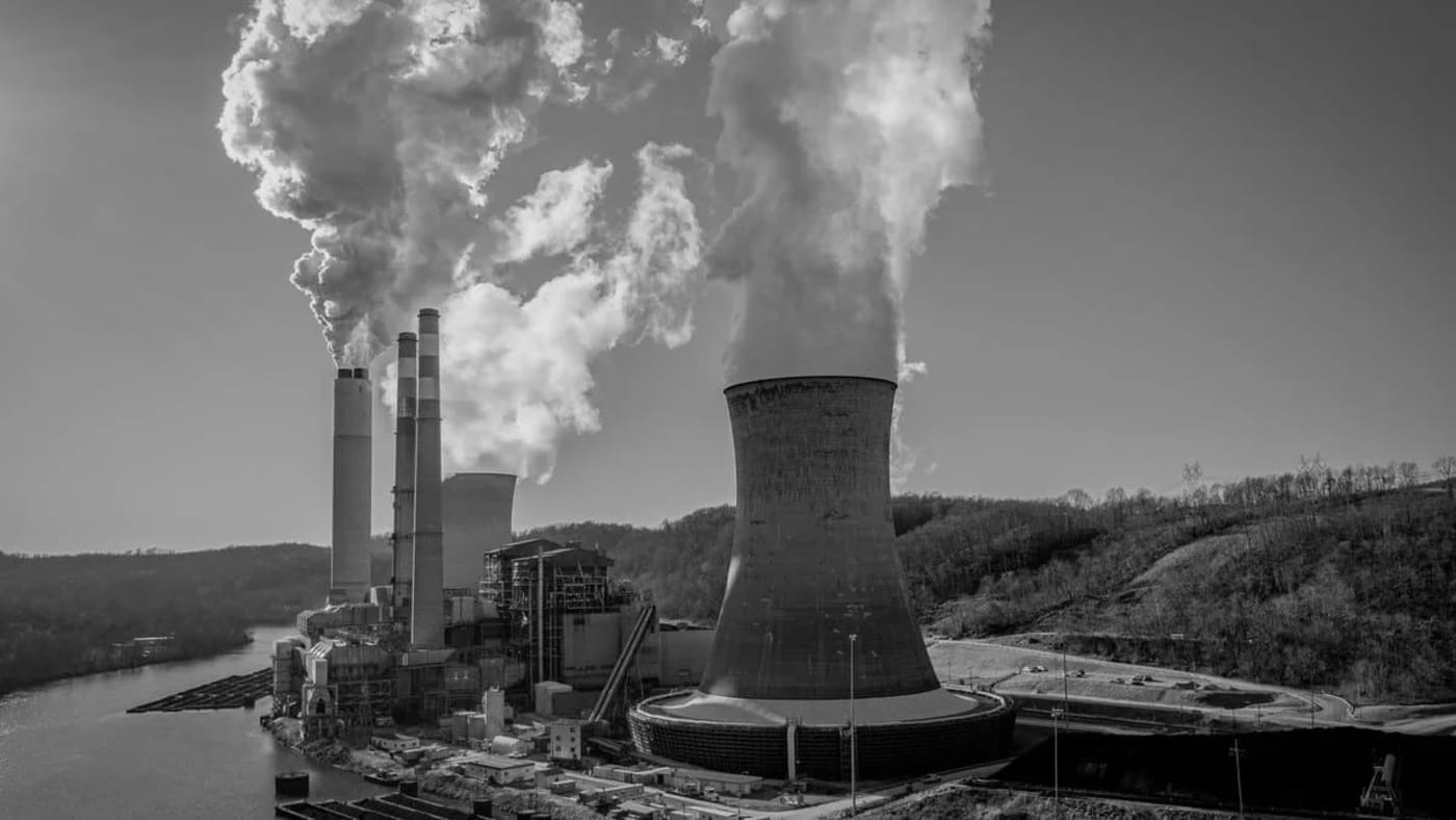 Vista aérea de una planta de carbón en Estados Unidos con torres de enfriamiento y humo saliendo de las chimeneas