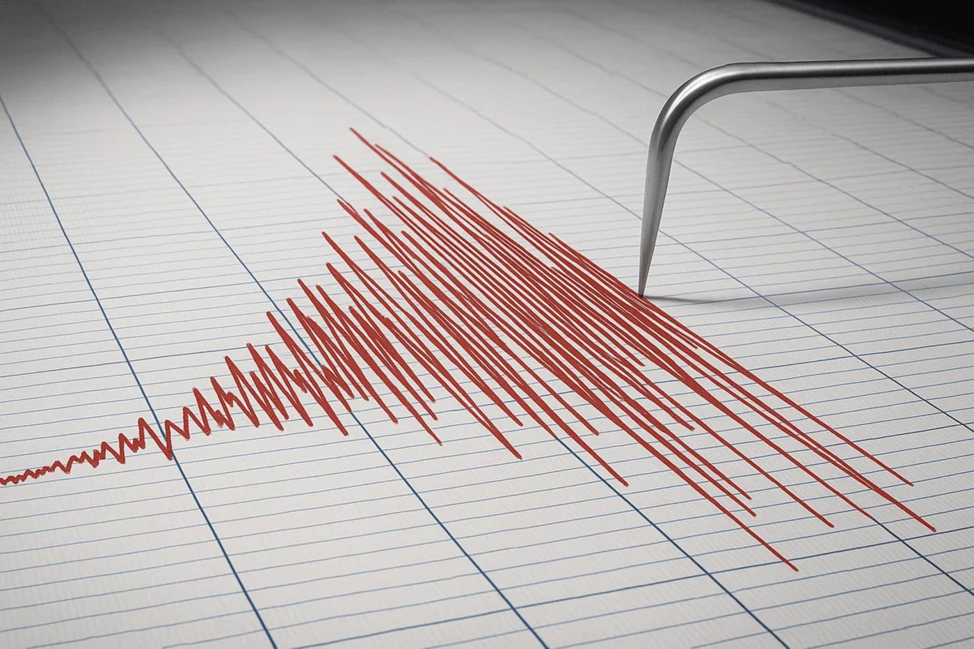 Gráfico de un sismógrafo registrando un fuerte movimiento sísmico con líneas rojas sobre papel cuadriculado