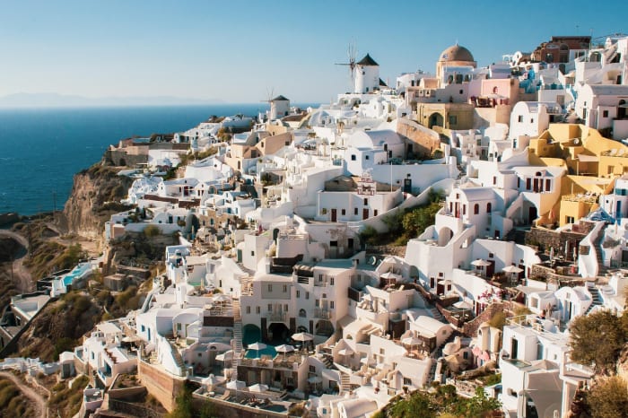 Vista panorámica de Santorini con sus casas blancas en terrazas sobre el acantilado, frente al mar Egeo