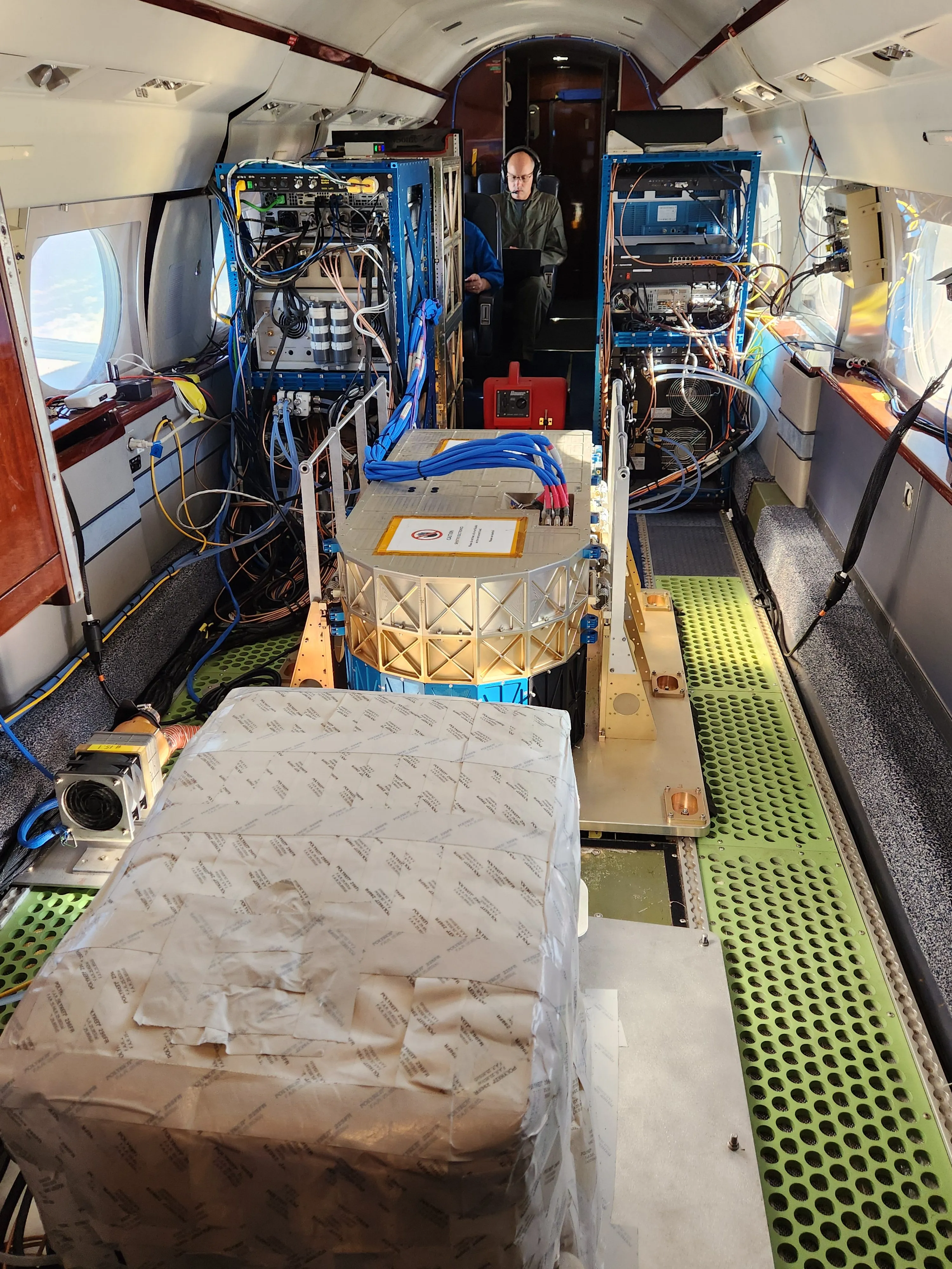 Vista del interior del avión G-III de la NASA mostrando los instrumentos AWP y HALO instalados para investigación atmosférica.