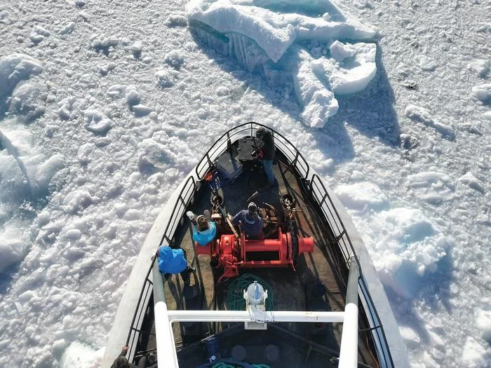 Proa de buque rompiendo hielo en fiordo ártico