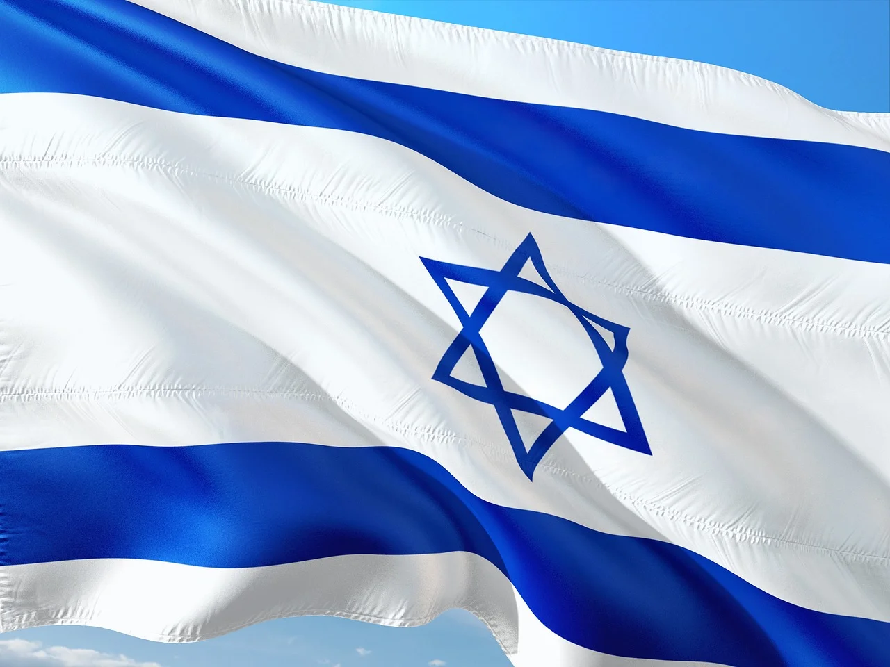 Bandera de Israel ondeando con fondo de cielo azul