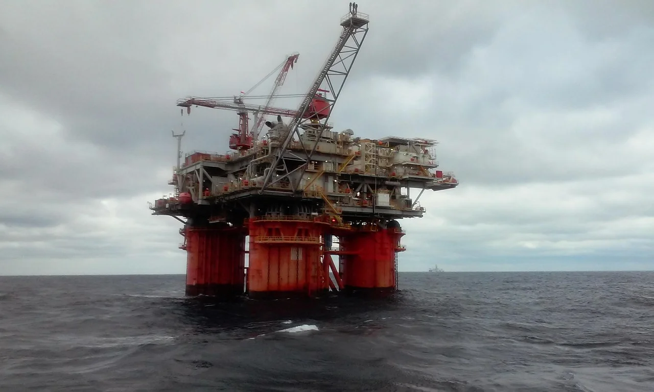 Plataforma petrolera en alta mar sobre el océano con estructuras metálicas y grúas