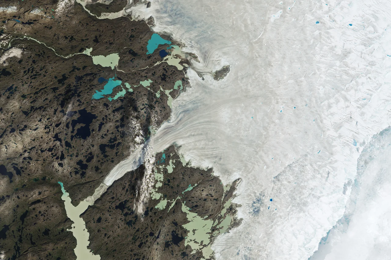Capa de hielo de Groenlandia con bandas grises y charcos azules de fusión tras el pico de derretimiento de agosto