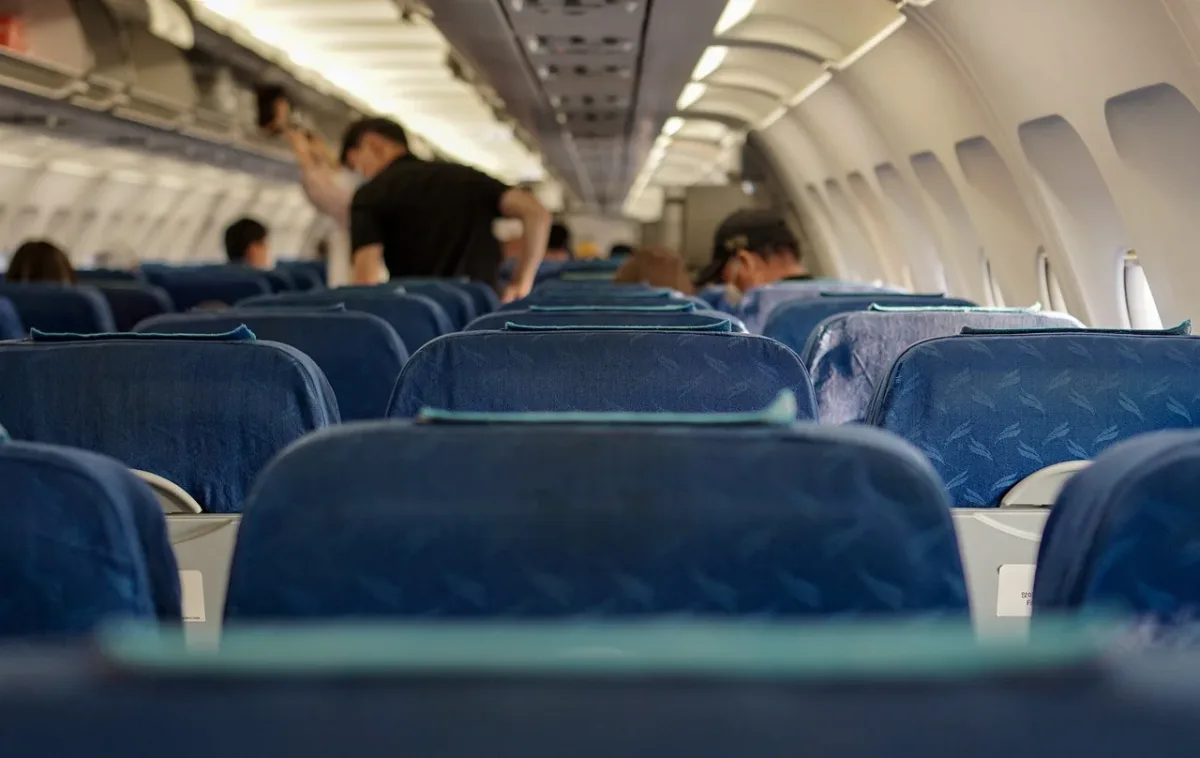 Interior de un avión de la aerolínea Delta con pasajeros abordando