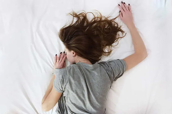 A Woman Sleeping on Her Stomach Without a Pillow
