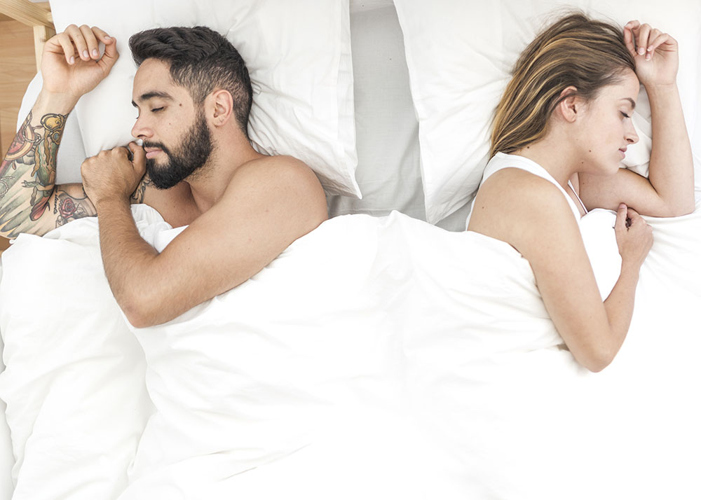 Couple sleeping on either side