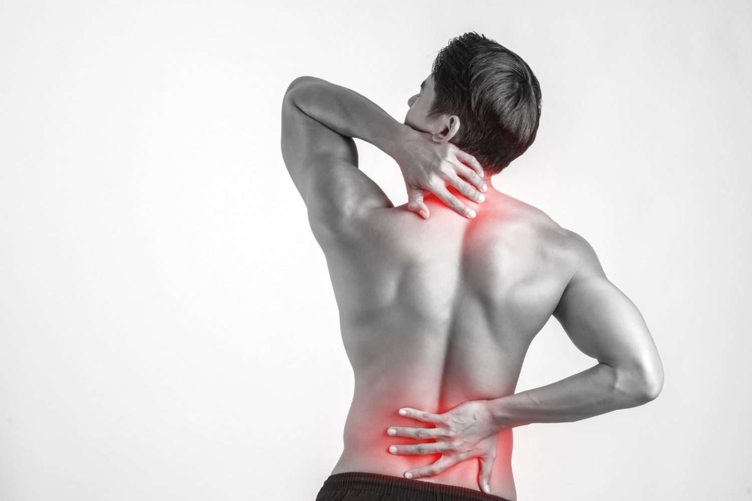 A man wrapping his hands at the back of his neck and his lower back due to pain