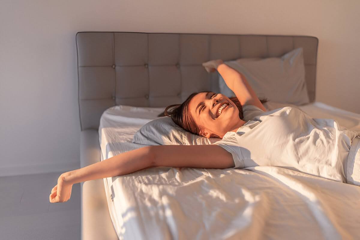 A woman waking up after a comfortable and good night’s sleep