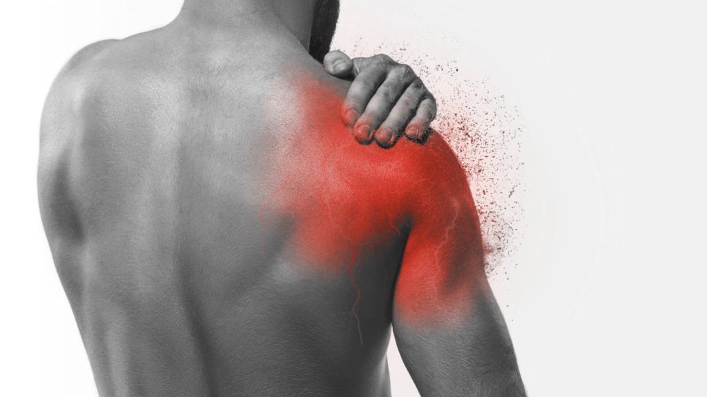 A man holding his shoulder, indicating pain or discomfort.