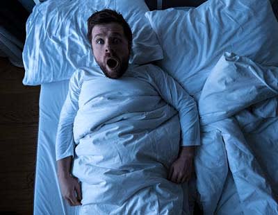 A man waking up in shock
