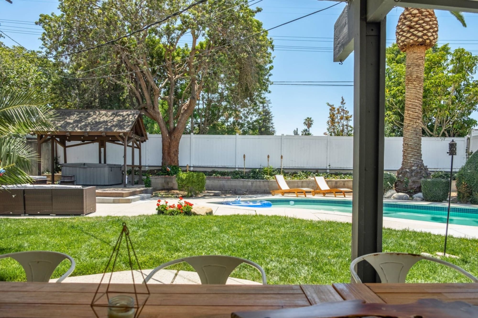 The glass-walled atrium dissolving the boundary between interior and garden.