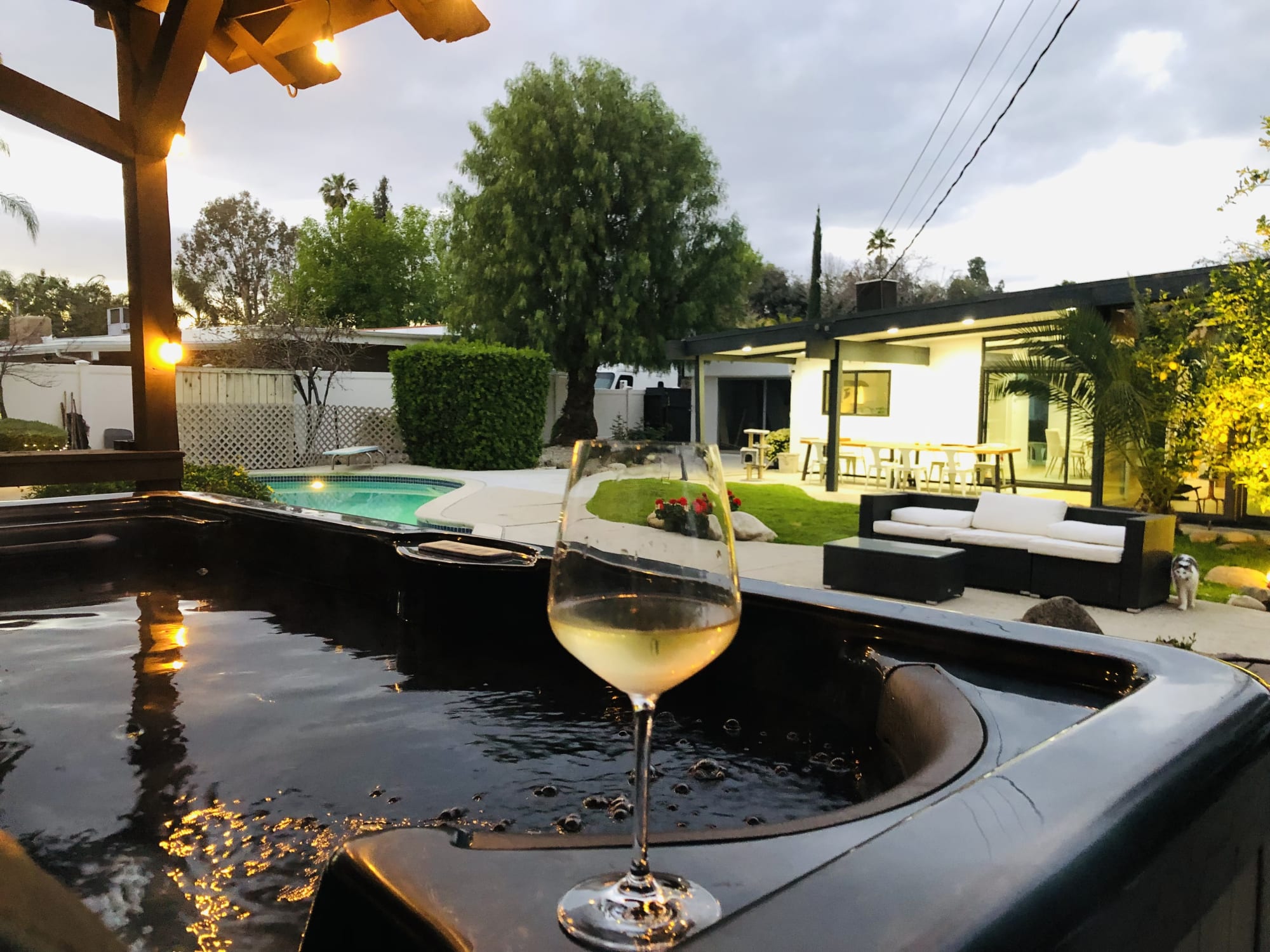 The spa terrace at dusk, soft light settling over the garden.