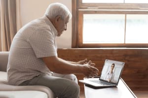 Multilingual staff on a call with elderly man