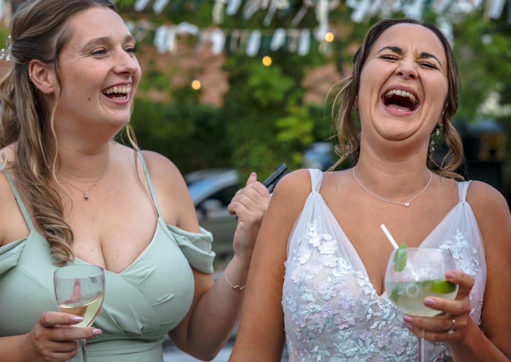 Bride laughing with a bridesmaid