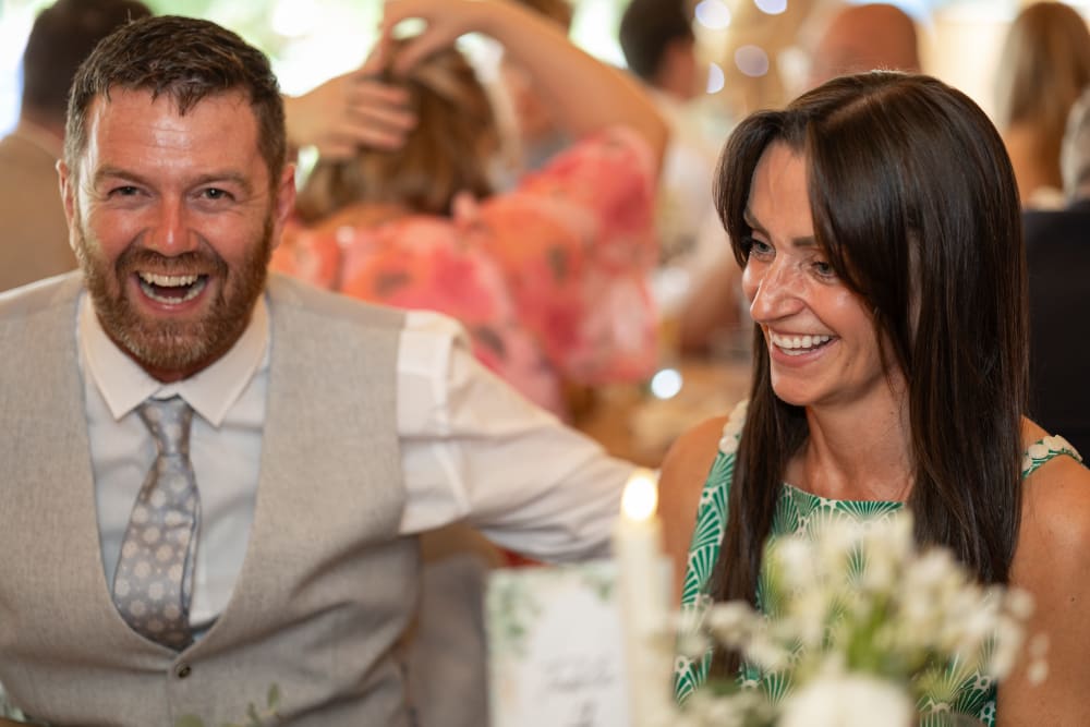 Guests sharing a joke at the reception