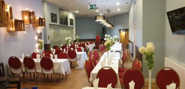 Intimate wedding setup in coffee shop area with draped lighting