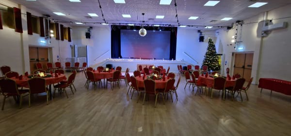 Christmas party with stage, festive lighting and projection screen