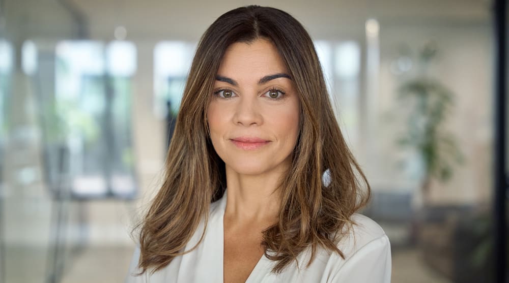 Confident female patient with natural facial rejuvenation results after deep plane facelift procedure in clinical setting