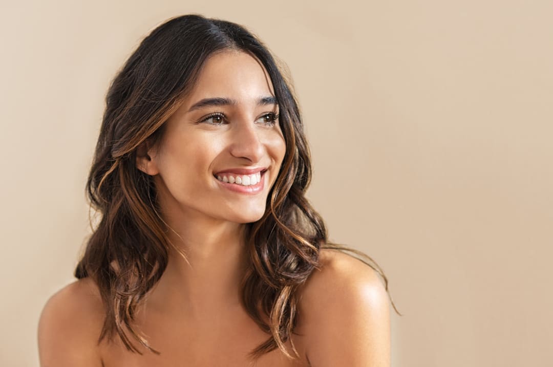 Facial fat transfer procedure: Smiling woman with balanced, youthful facial contours