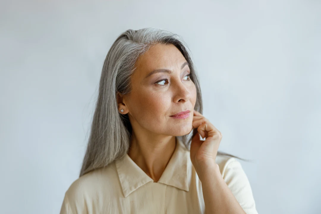Mature woman with firm, smooth facial skin illustrating AVAVA skin tightening laser treatment.