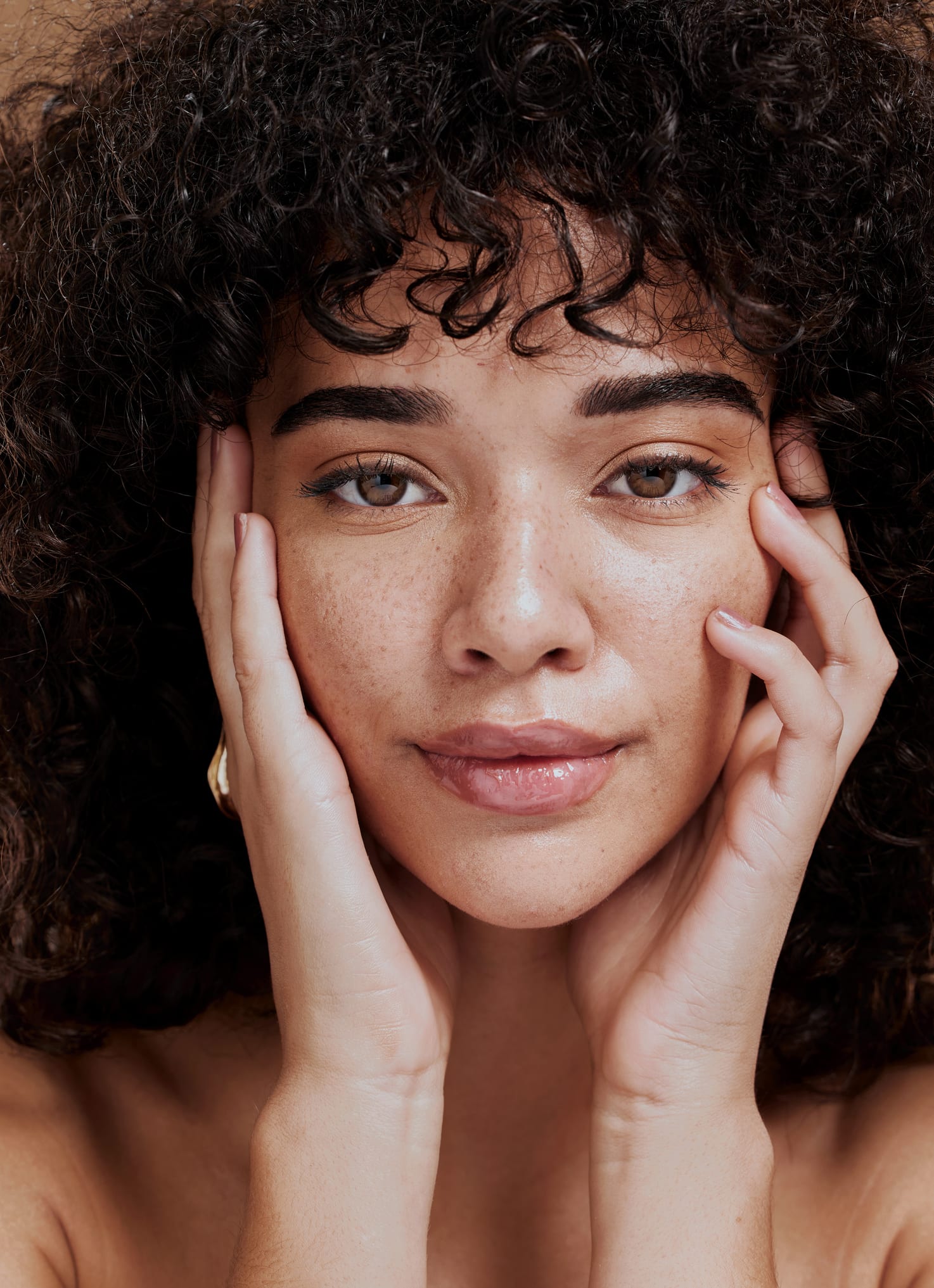 Facial fat transfer procedure: Woman touching her cheeks with smooth facial contours