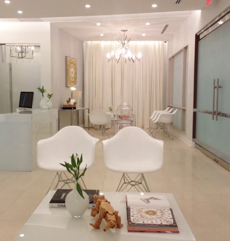 Medical office interior: Modern white reception and waiting area with contemporary seating