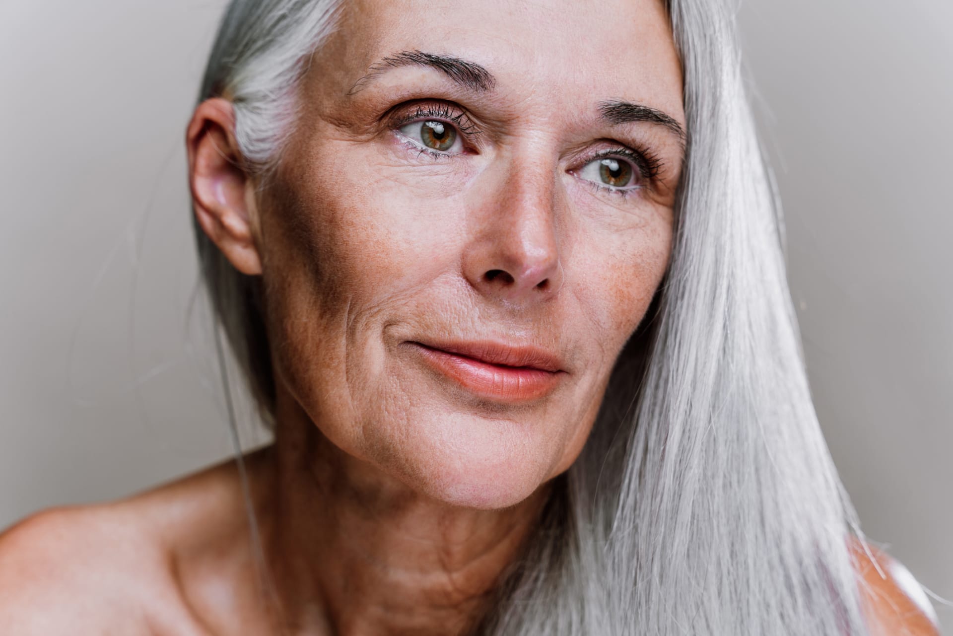 Woman with mature skin illustrating AVAVA laser skin tightening and rejuvenation treatment.