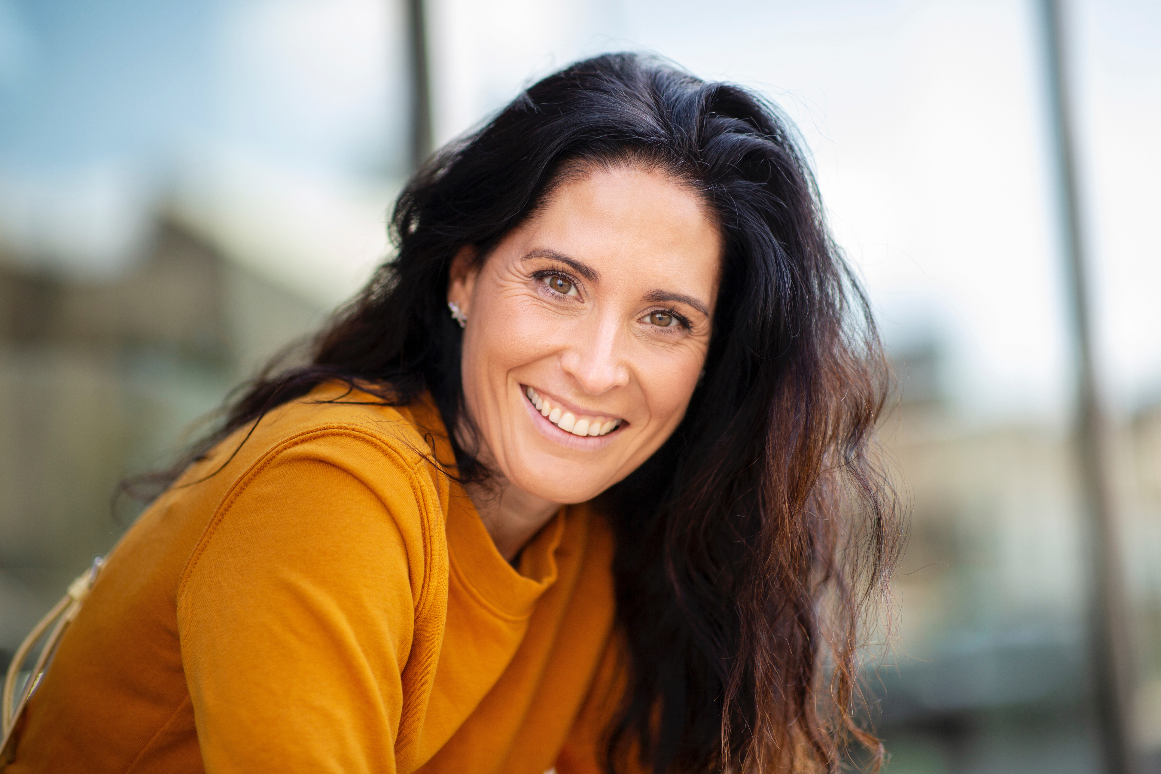 Woman smiling after cheek lift surgery