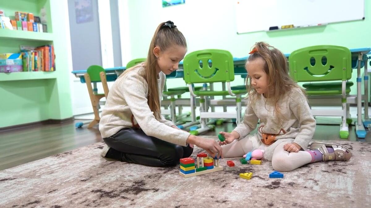 Anna, 10, and Sofia, 5, play in a Child Friendly Space in Zaporizhzhia, Ukraine