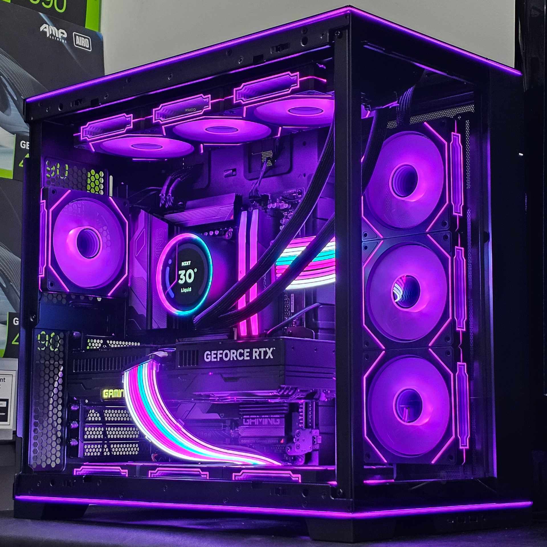 Completed gaming PC build with RGB lighting visible through a tempered glass side panel
