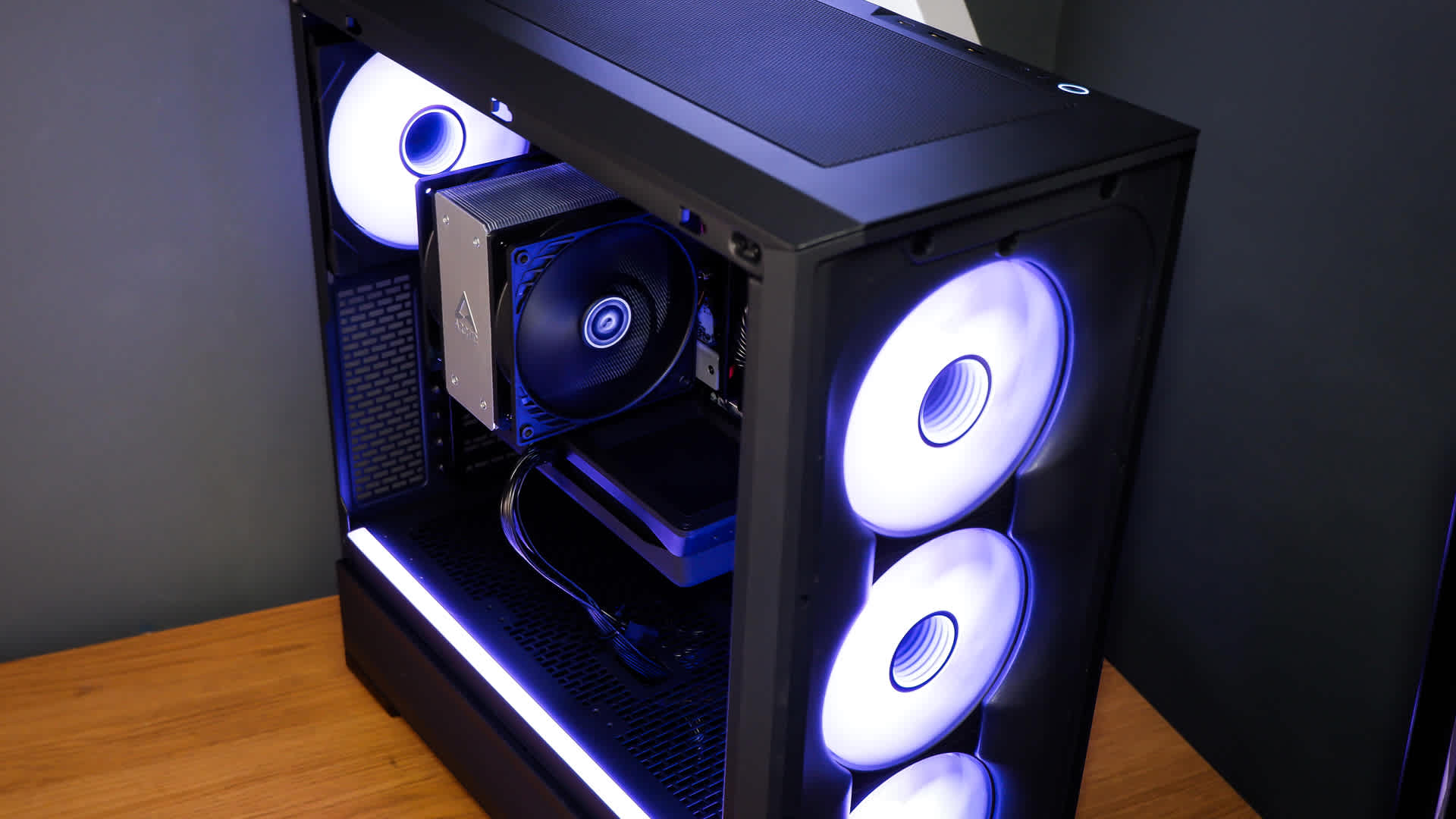 Completed budget gaming PC build with the side panel removed showing graphics card and cooler