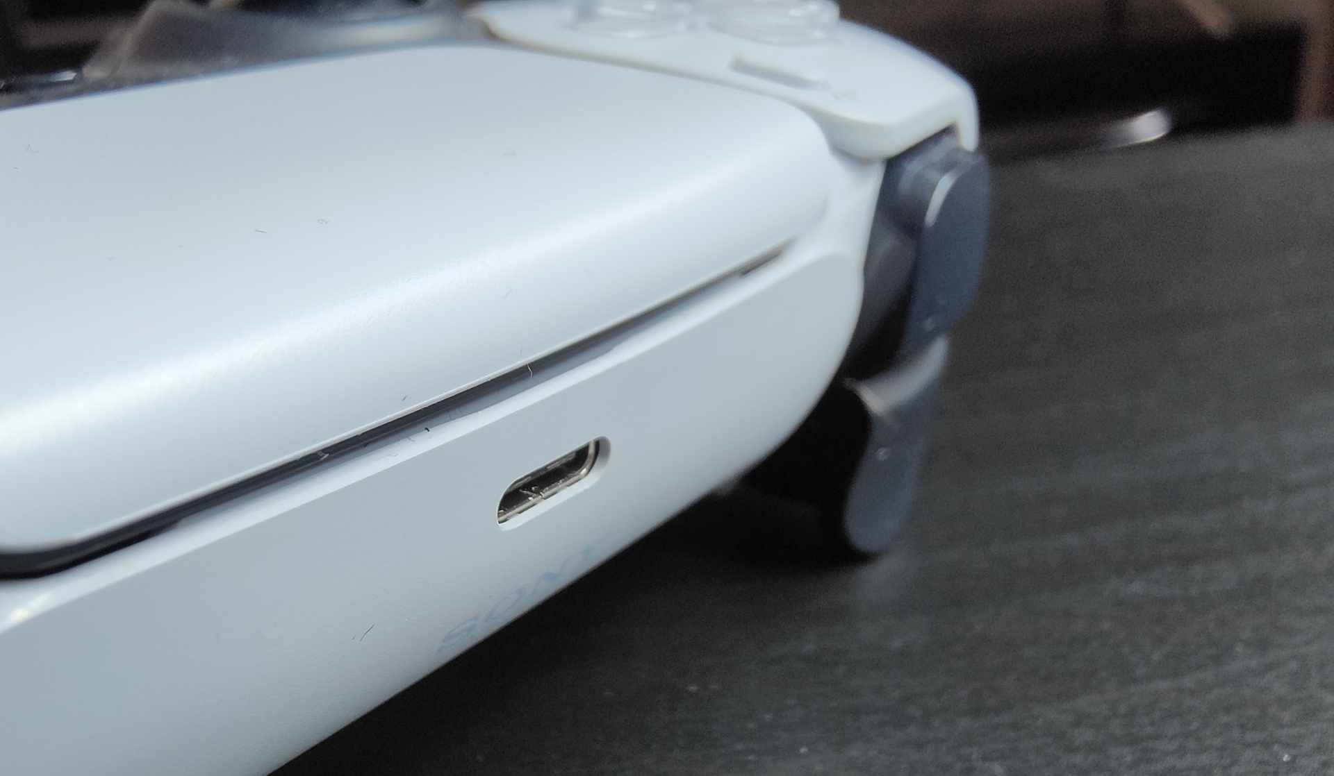 Close up of the USB-C charging port on the top edge of a DualSense controller