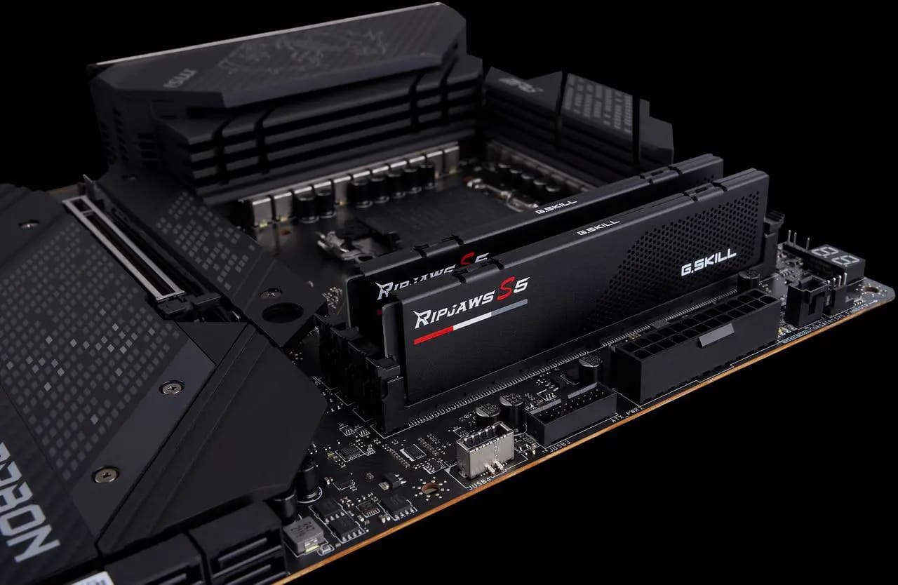 A DDR5 memory kit resting on its packaging beside a new build