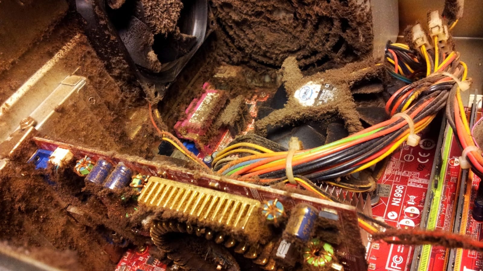 Dust accumulation clogging the fans and heatsink fins inside a gaming PC