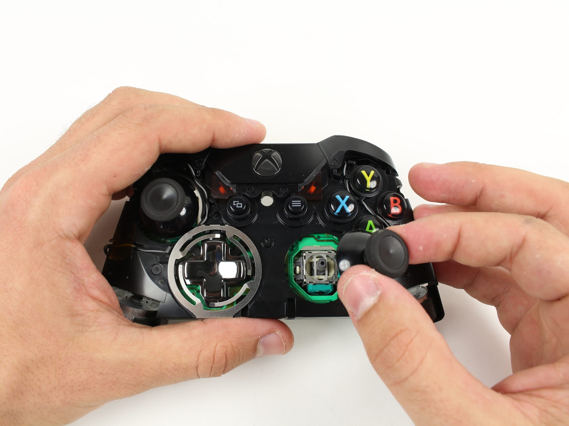 Game controller thumbstick module removed from the board, showing the gimbal and sensor assembly