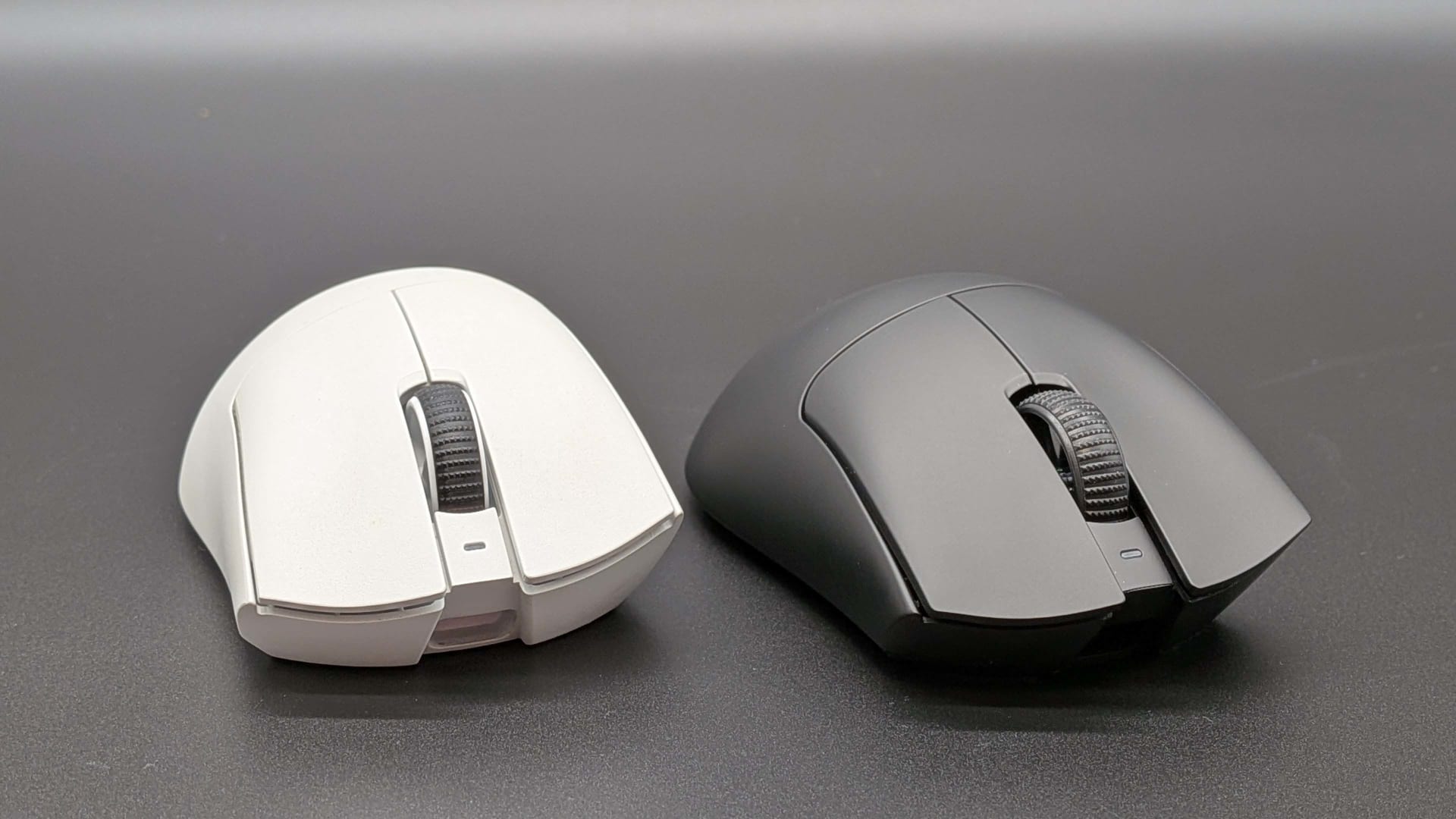 Wireless gaming mouse beside the high-polling receiver dongle that must be plugged directly into the PC