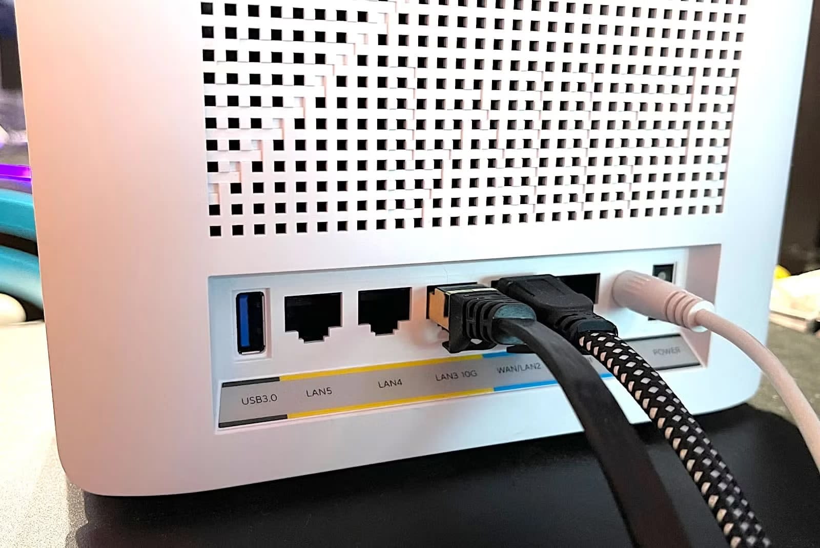 Ethernet cables plugged into the LAN ports on the back of a home router