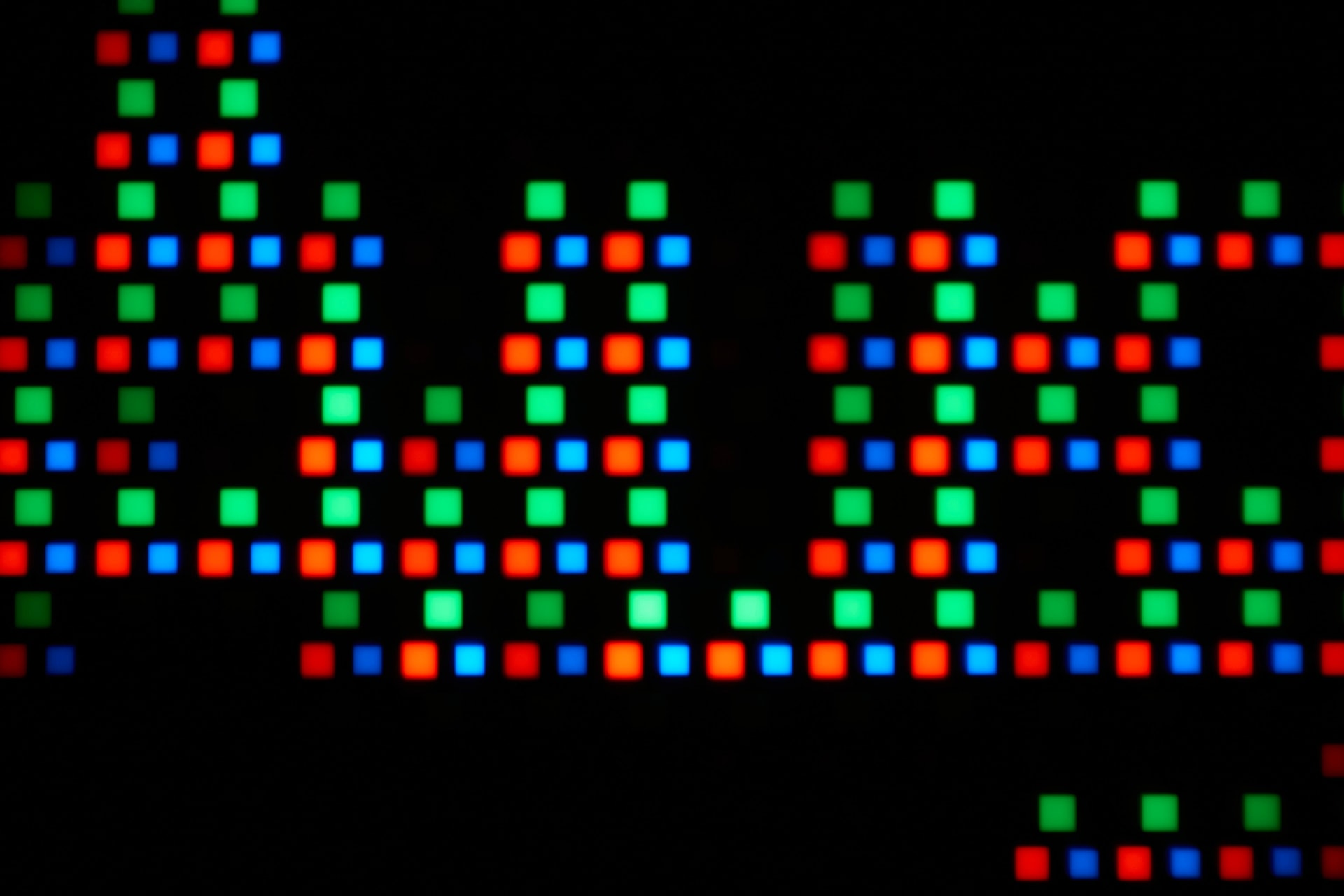 Macro photograph of an OLED monitor subpixel layout showing the arrangement of red green and blue emitters