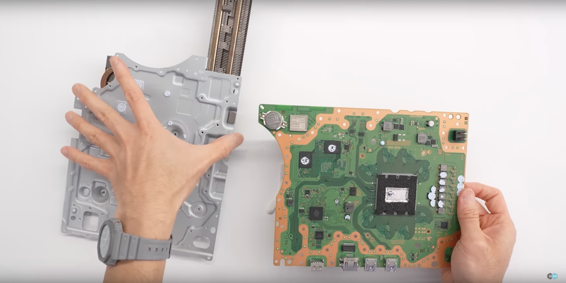 The detachable PS5 disc drive assembly shown separated from the console body