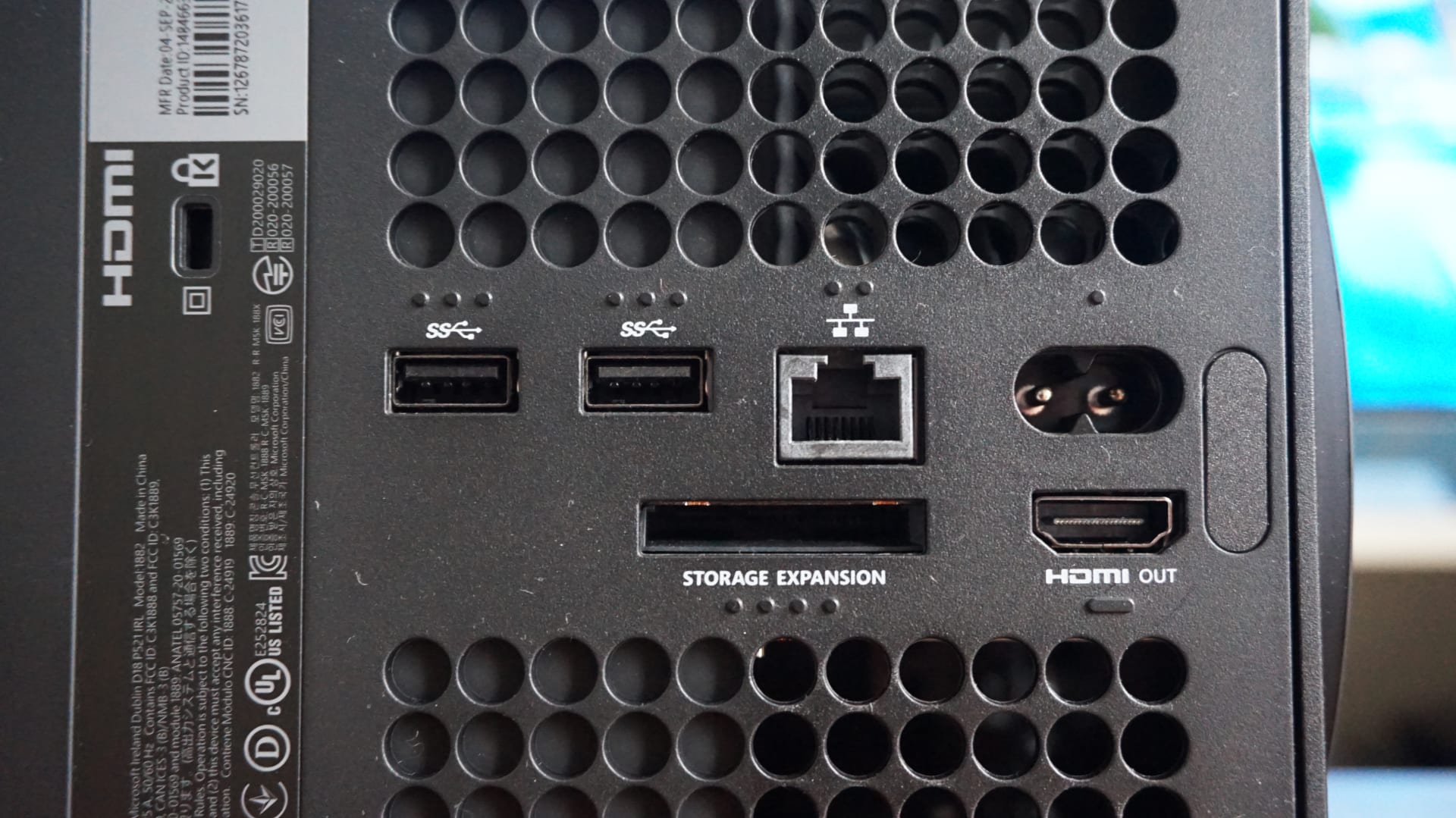 The rear of an Xbox Series X showing the power inlet, HDMI output and storage expansion slot
