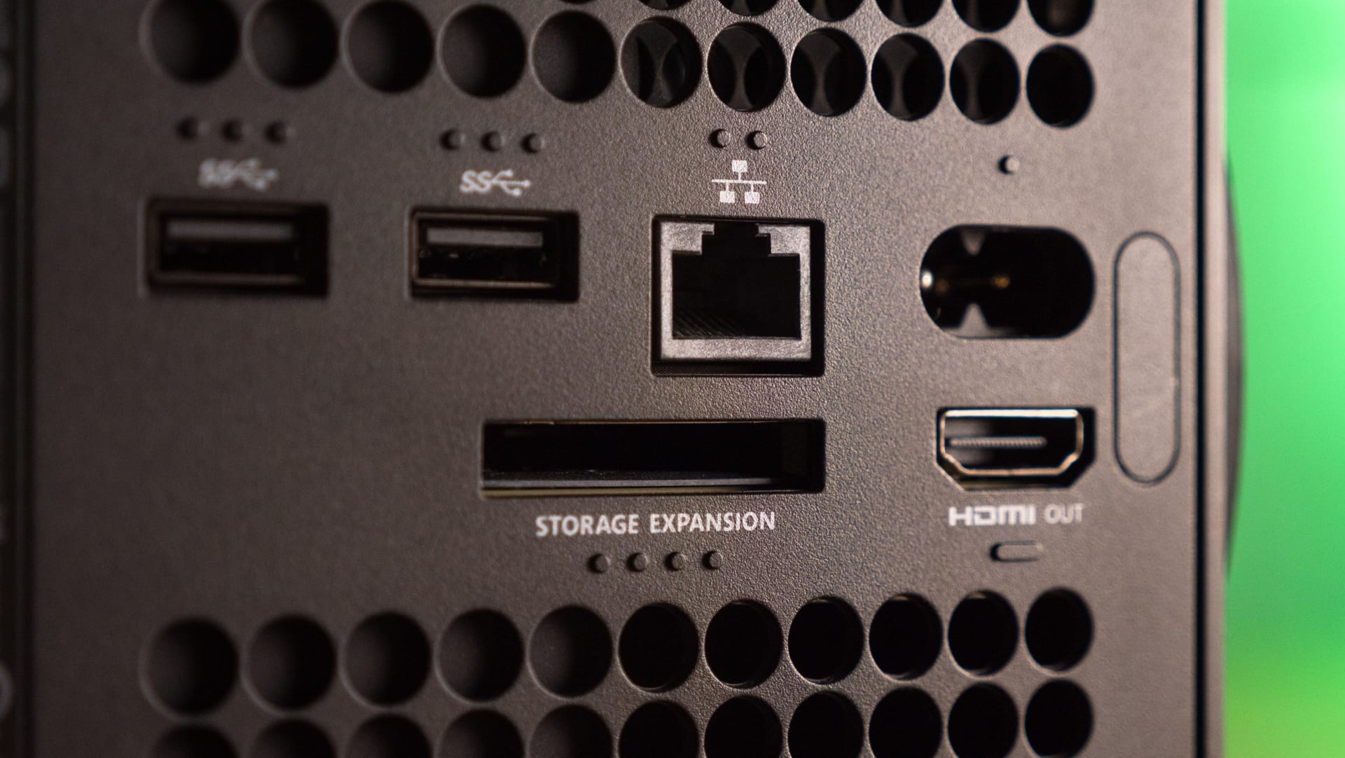 An expansion card being inserted into the dedicated storage slot on the back of an Xbox Series X