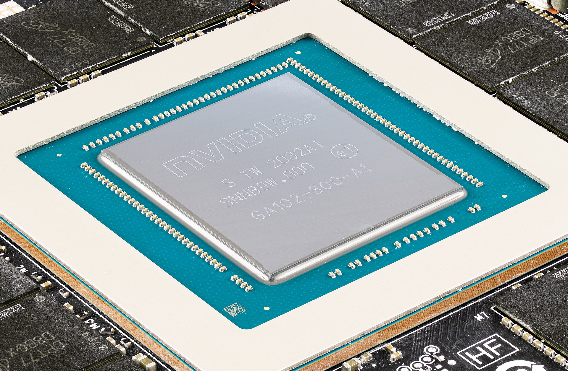 Macro photograph of a GPU die on its package ringed by the graphics card's GDDR memory chips