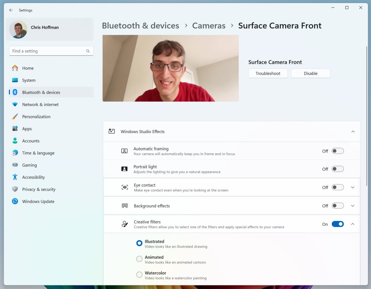 Windows 11 camera settings page listing Windows Studio Effects toggles for automatic framing, portrait light, eye contact, background effects and creative filters