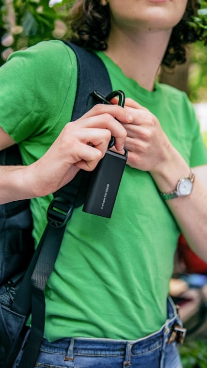 A man in a green shirt holding a cell phone