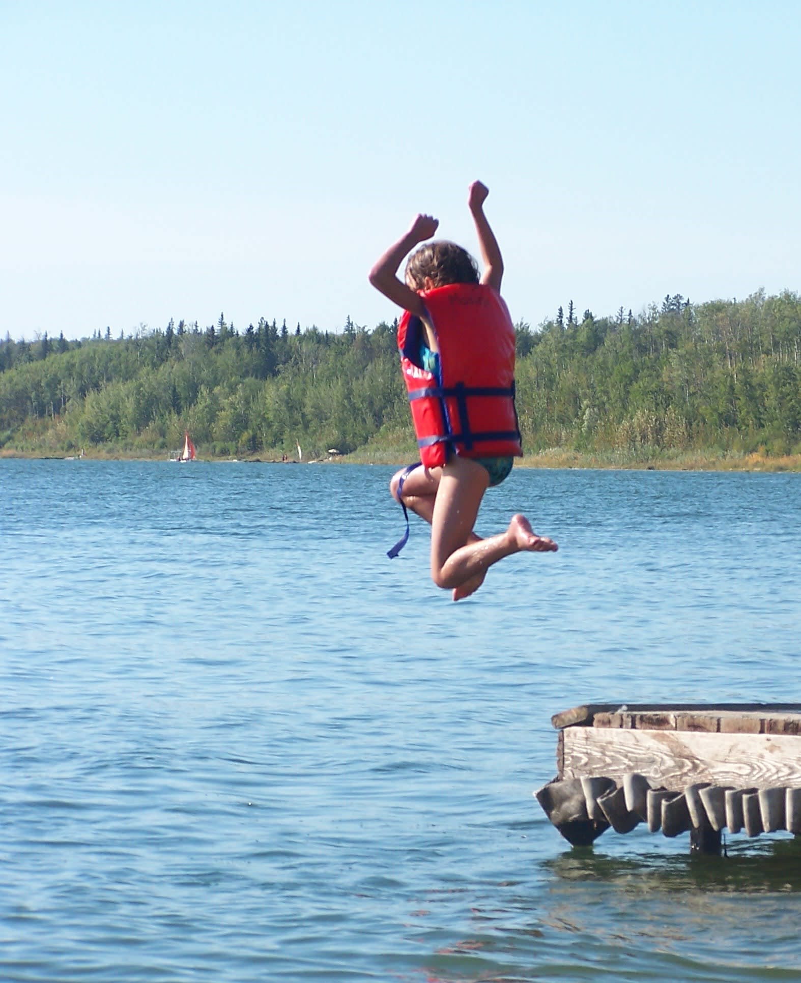 kid jumping into the lake