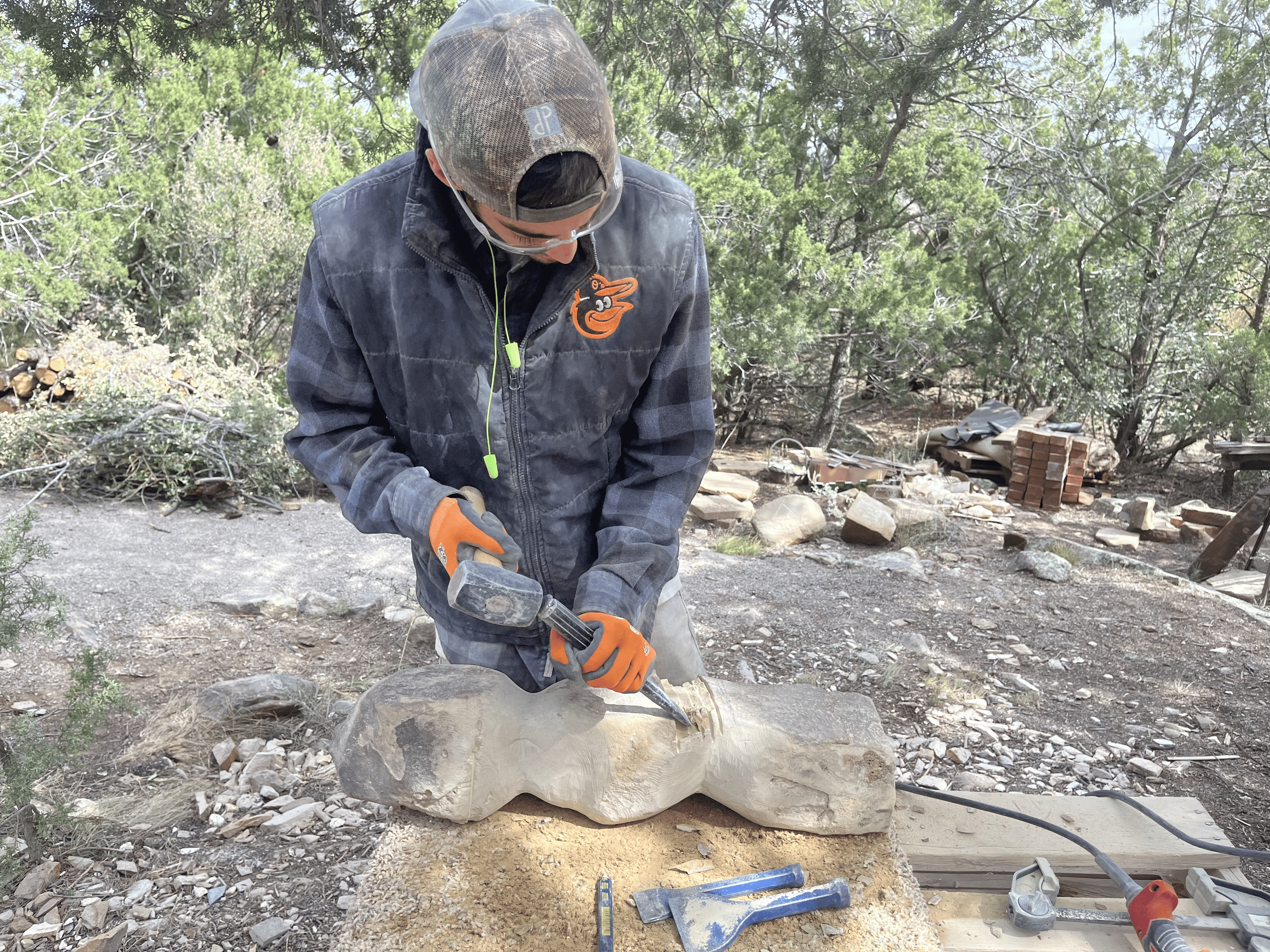 Dan Quinn hand-chiseling a sandstone sculpture in his studio, Genesee Valley Stone Works
