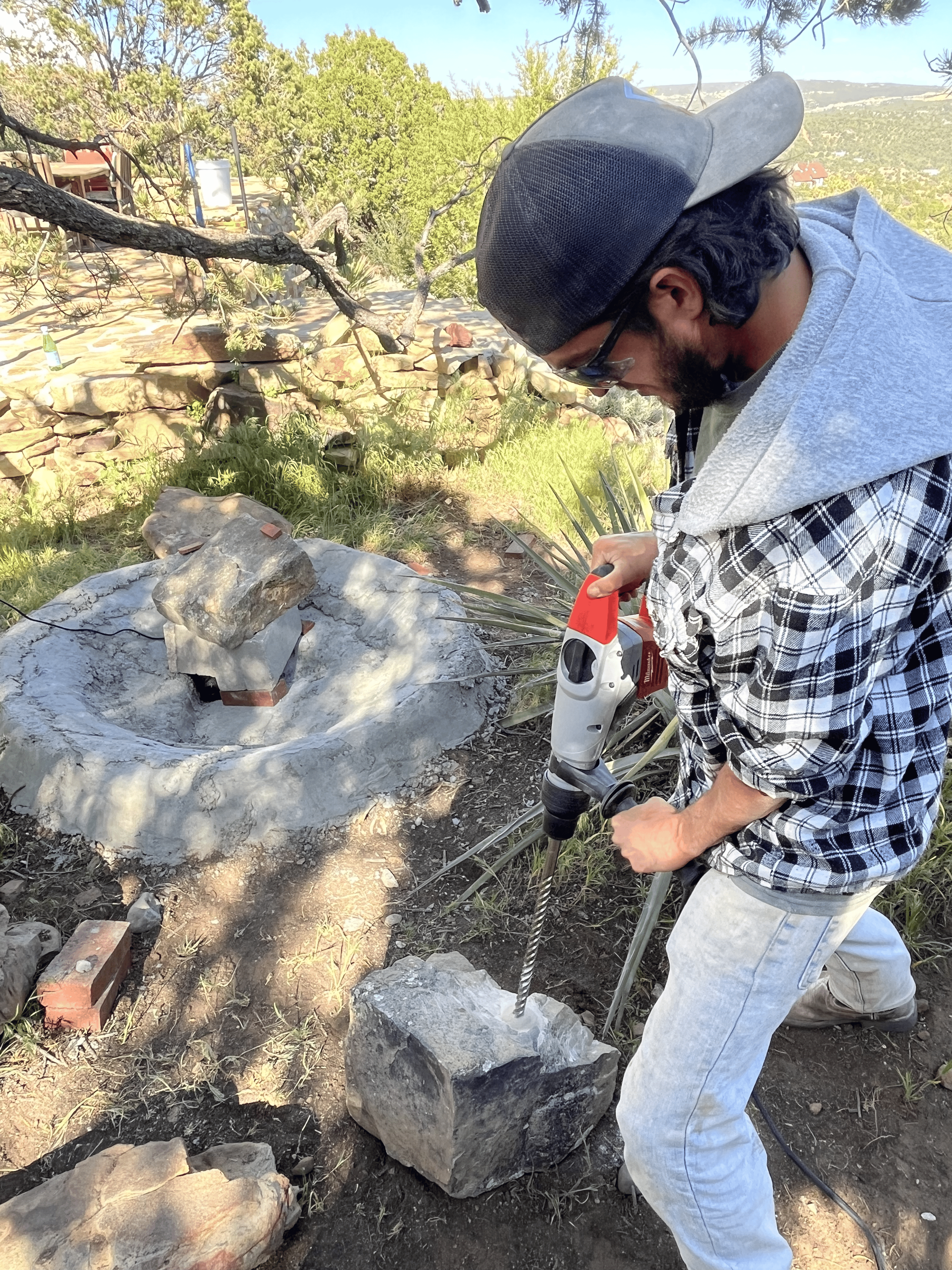 Drilling a stone fountain base during custom fabrication, Genesee Valley Stone Works Rochester NY