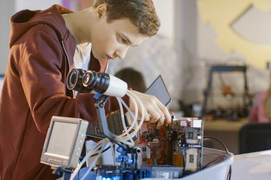 A boy programming a robot