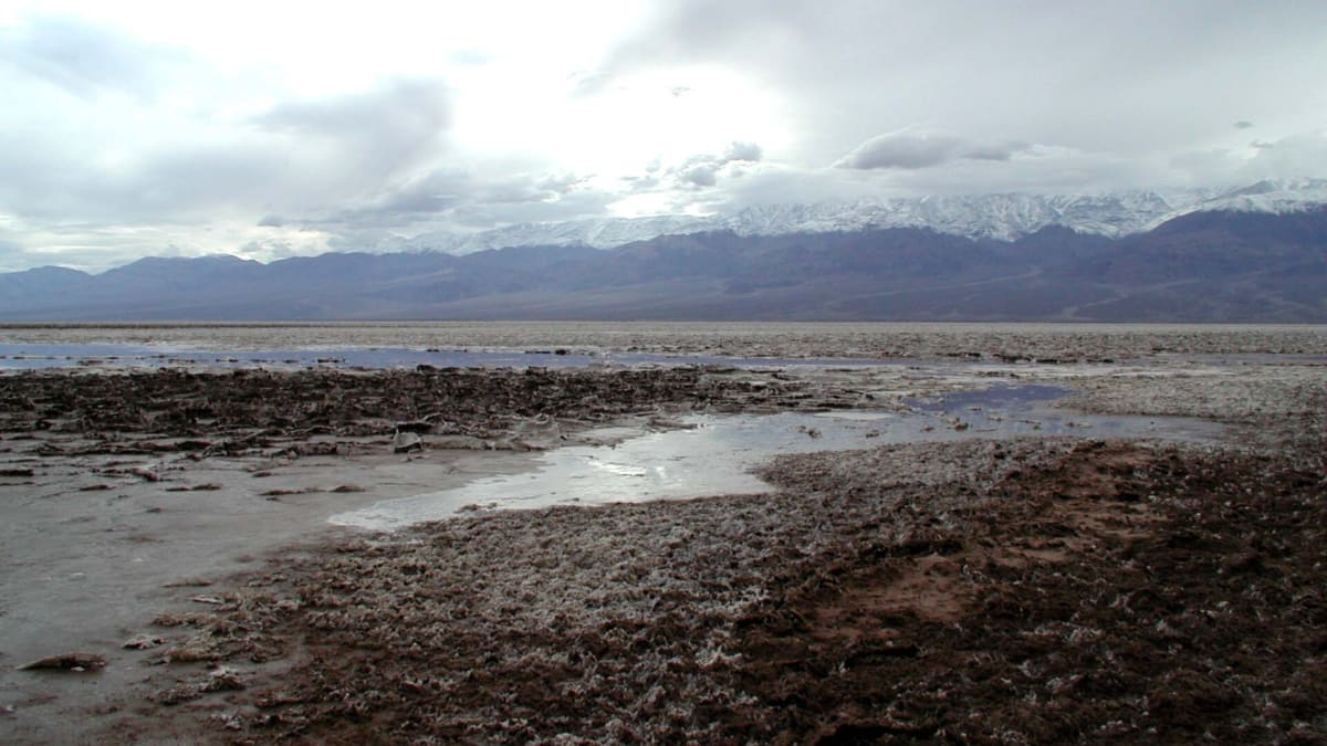 The white salt flats of Badwater Basin beneath desert mountains, Death Valley National Park, California